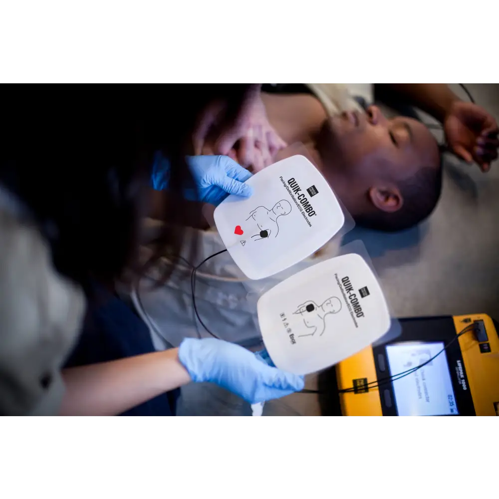 A woman prepares AED pads to save a mans life