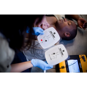 A woman prepares AED pads to save a mans life
