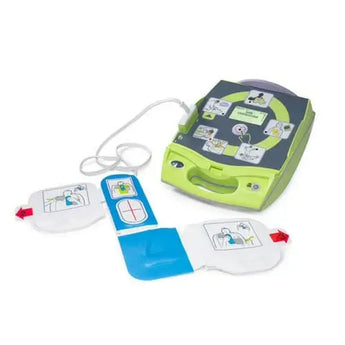 Green and gray defibrillator with blue pads