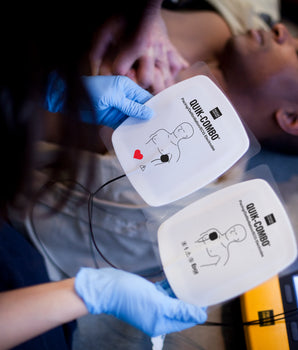 A woman prepares AED pads to save a mans life