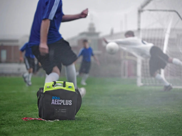 An AED in a cary bag waiting for possible use on a soccer pitch.